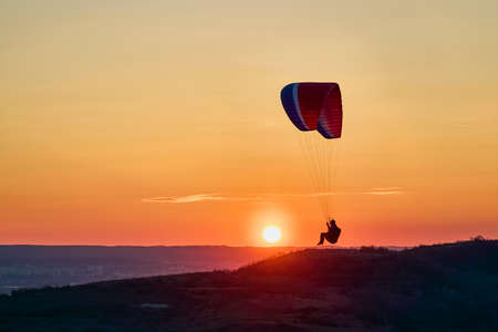Valeni Arges Romania April 5, 2022: evening training of some skydiving enthusiasts at sunset.のeditorial素材