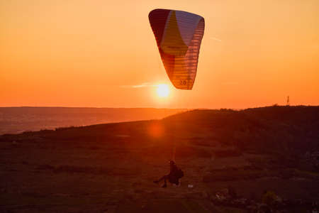 Valeni Arges Romania April 5, 2022: evening training of some skydiving enthusiasts at sunset.のeditorial素材
