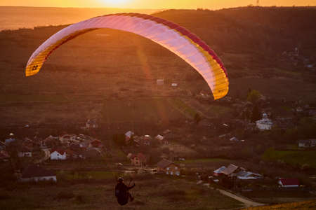 Valeni Arges Romania April 5, 2022: evening training of some skydiving enthusiasts at sunset.のeditorial素材