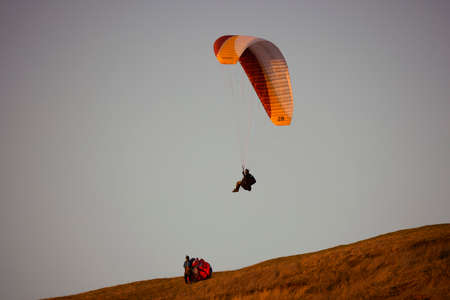 Valeni Arges Romania April 5, 2022: evening training of some skydiving enthusiasts at sunset.のeditorial素材