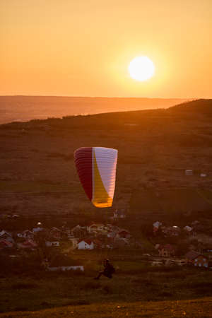Valeni Arges Romania April 5, 2022: evening training of some skydiving enthusiasts at sunset.のeditorial素材