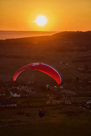 Valeni Arges Romania April 5, 2022: evening training of some skydiving enthusiasts at sunset.のeditorial素材