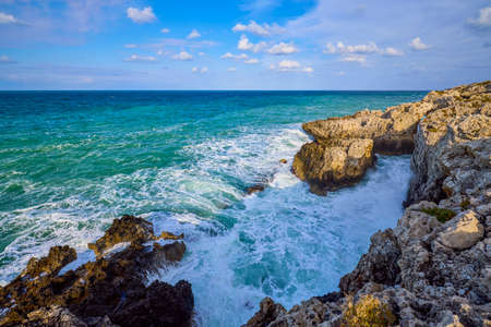 Beautiful landscape with a rocky sea shore on a sunny dayの写真素材