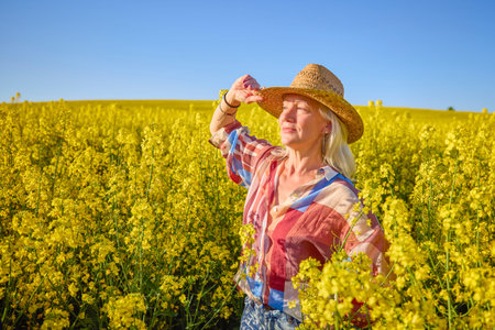 Portrait of a middle-aged woman in the rapeseed chain.