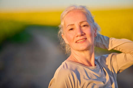 Portrait of a middle-aged woman in the rapeseed chain.の写真素材