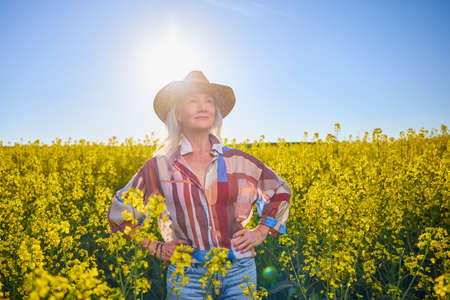 Portrait of a middle-aged woman in the rapeseed chain.の写真素材