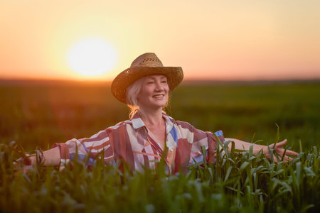 portrait of a middle-aged woman in the wheat field at sunset
