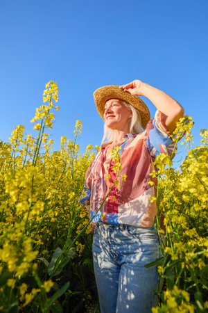 Portrait of a middle-aged woman in the rapeseed chain.
