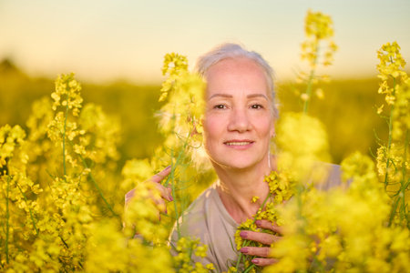 Portrait of a middle-aged woman in the rapeseed chain.の写真素材