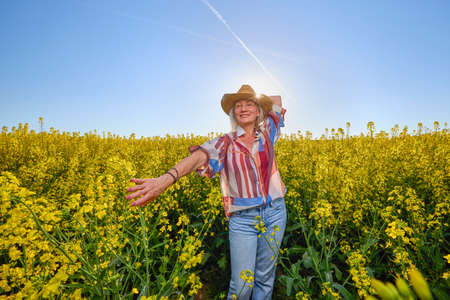 Portrait of a middle-aged woman in the rapeseed chain.の写真素材