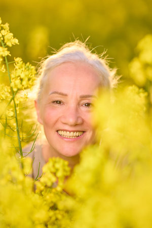 Portrait of a middle-aged woman in the rapeseed chain.