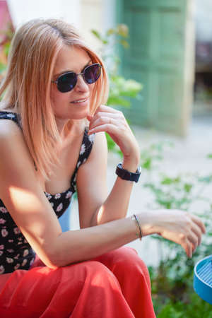 Portrait of a beautiful blonde woman with sunglassesの写真素材