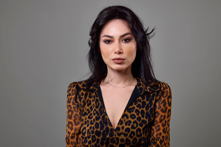 Beautiful portrait of a brunette woman wearing an animal print dress.