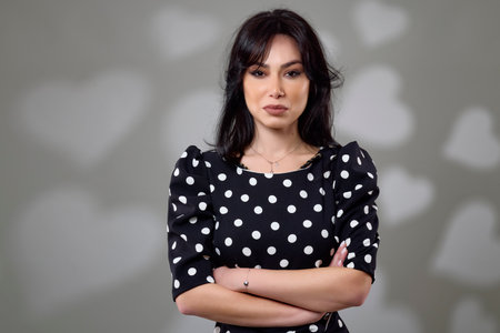 an elegant brunette woman in a dress in the studioの写真素材