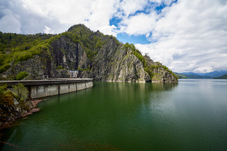 landscape with the Vidraru dam in the Carpathian mountains in Romania during springの写真素材