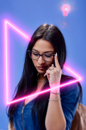 a young brunette with long hair posing in the studio with a backpack, Back to school concept.の写真素材