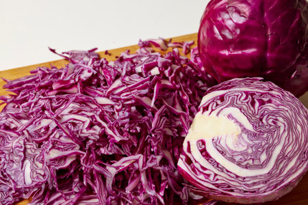 Chopped red cabbage on a wooden chopper.の写真素材