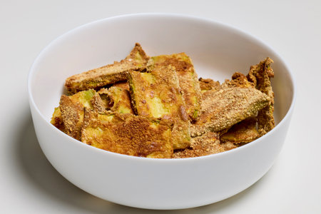 a bowl with slices of cooked breaded zucchini.の写真素材