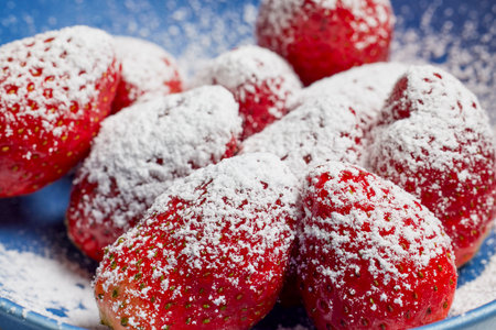 Strawberries in a plate on a table ready to be eaten.の写真素材