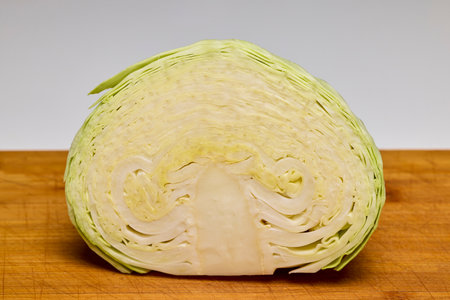 Fresh cabbage cut in half on a tableの写真素材