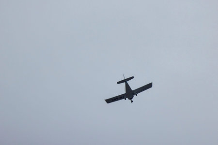 an airplane in flight in the sky on a sunny day.