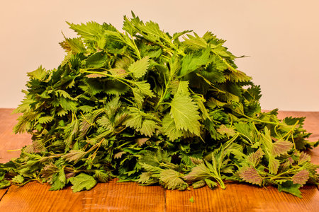 a bunch of nettles on a wooden table.