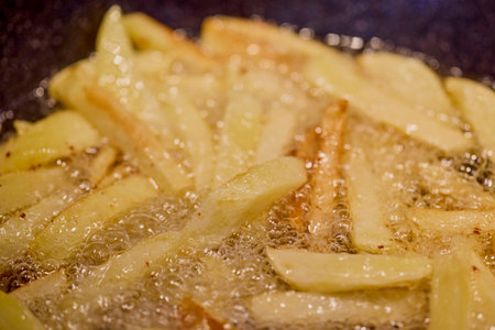 image of potatoes in a pan while frying.の写真素材