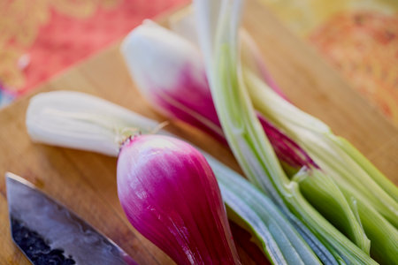 fresh red onion on a wooden chopper.の写真素材