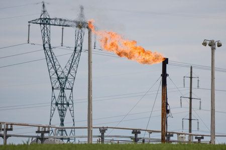 an oil rig with a large burning flame
