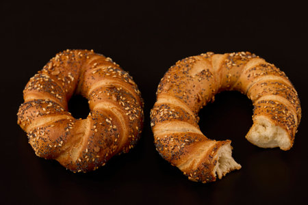 pretzel with mixed seeds on a table on a black background