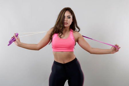 beautiful woman with a rope in different poses isolated on gray background