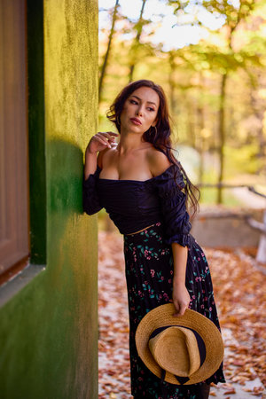 a beautiful woman with a hat in autumnの写真素材