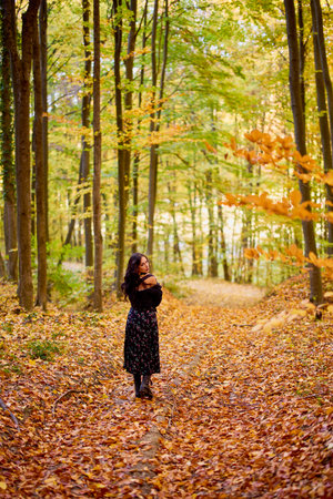 portrait of a beautiful woman in autumn in the forestの写真素材