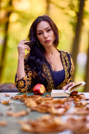a woman sits at a table in the forestの写真素材