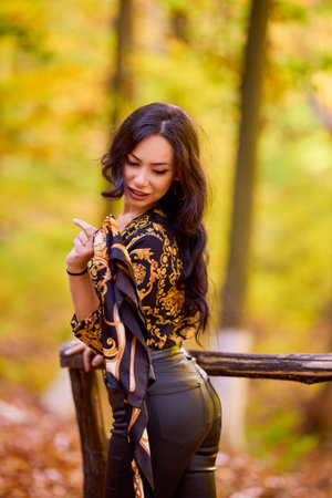 a woman with a scarf in her hand is enjoying the autumn landscapeの写真素材