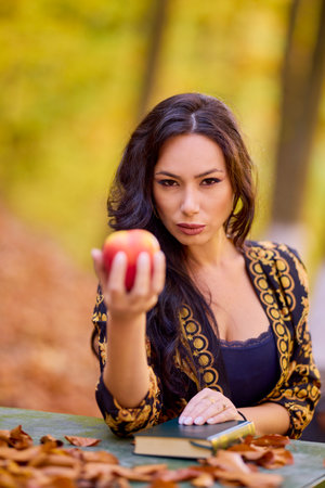 a woman sits at a table in the forestの写真素材