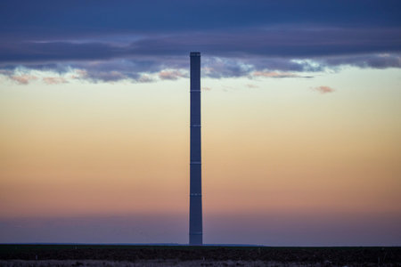 Industrial pipe on the background of blue thick clouds