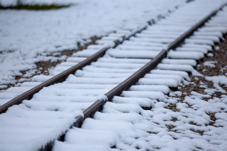 a railway covered with snow on a winter dayの写真素材