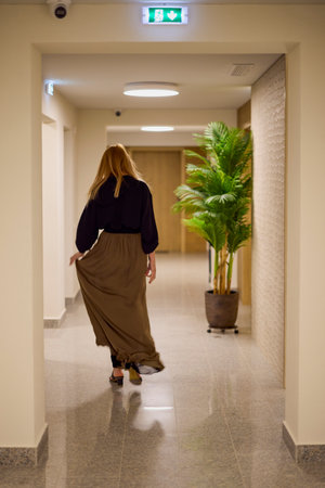 portrait of a middle-aged woman in a hallway at work.の写真素材