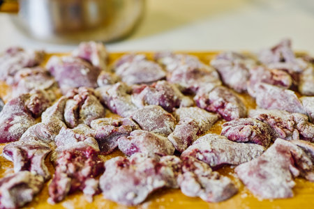 Chicken livers, floured on a wooden board