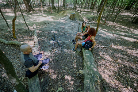 A group of people hiking through the forest and relaxing on a sunny summer day