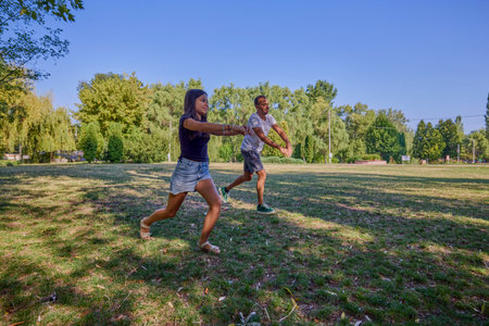 Father and daughter spending time together in the park exercising and relaxing.の写真素材