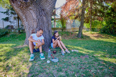 Father and daughter spending time together in the park exercising and relaxing.