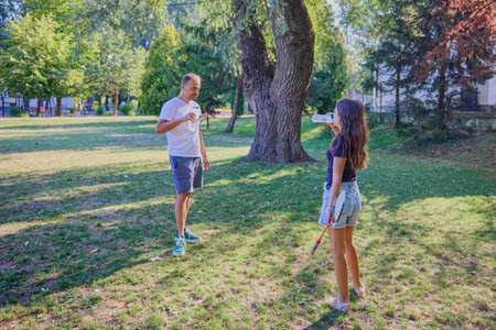 Father and daughter spending time together in the park exercising and relaxing.の写真素材