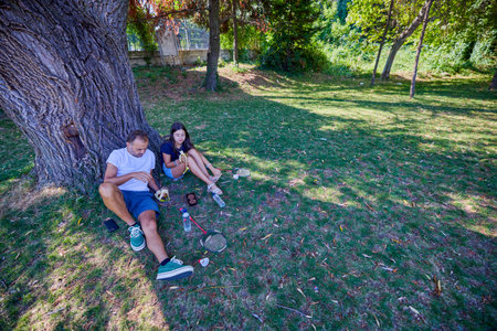 Father and daughter spending time together in the park exercising and relaxing.の写真素材