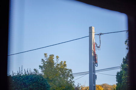 a power pole seen through a windowの写真素材