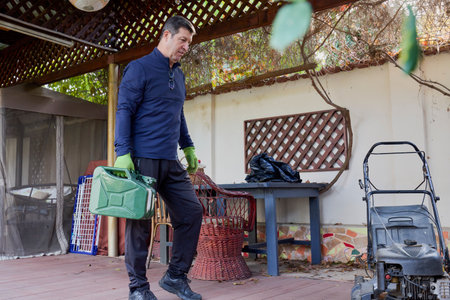a middle-aged man working in his home garden doing various gardening activitiesの写真素材