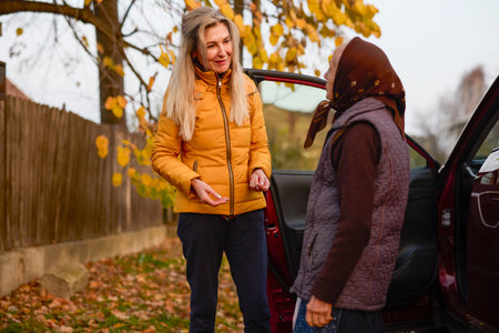Middle-aged woman visits her elderly motherの写真素材