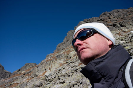 man witn sunglasses and mountain