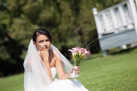 Unhappy bride with a wedding bouquetの写真素材